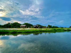 a view of a river with a house in the background at Angeles Campsite in San Antonio +13 photos
