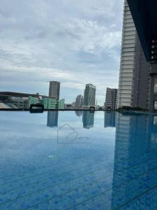 una grande piscina d'acqua con edifici sullo sfondo di Brand New Minimalist Suite 3 Min Walk to CIQ a Johor Bahru