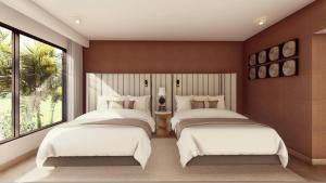 a bedroom with two beds and a large window at Faranda Collection Cartagena, a member of Radisson Individuals in Cartagena de Indias