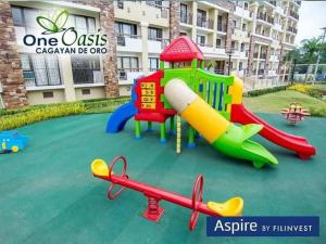 a playground in front of a apartment building at Cozy 2BR Condo-Central Location in Lapasan
