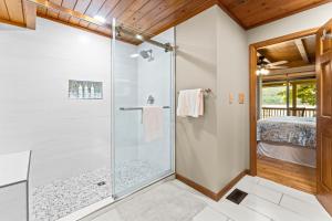 a bathroom with a shower with a glass door at Ma Cook Lodge - Sharps Chapel in Maynardville +42 photos