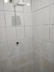 a bathroom with a white tiled shower at AP Gomes in Ananindeua