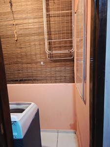a small bathroom with a toilet and a window at Casa Sonho de Verão in Ilha de Boipeba +39 photos