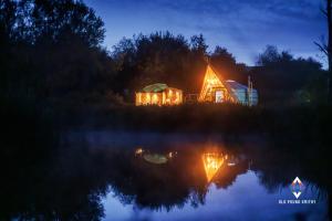 a cabin in the middle of a lake at night at Old Pound Smithy in Bideford +118 photos