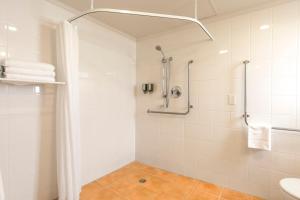 a bathroom with a shower and a sink at Greenlane Manor Motel in Auckland +27 photos