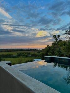 a swimming pool on the side of a house at Luxury 4BR home with Infinity Pool, Jacuzzi & firepit in Playa Hermosa