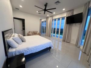 a bedroom with a bed and a ceiling fan at Luxury 4BR home with Infinity Pool, Jacuzzi & firepit in Playa Hermosa +17 photos