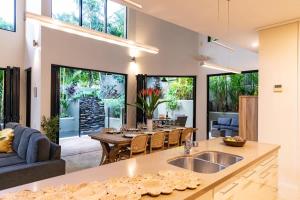 a kitchen and living room with a table and a couch at Villa Amalfi - Port Douglas in Port Douglas