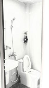 a white bathroom with a toilet and a sink at Ami Home in Hanoi +17 photos