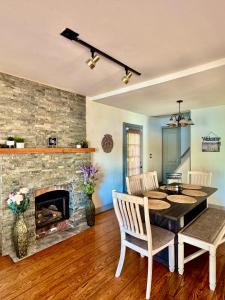 a dining room with a table and a fireplace at Cozy lake house in Nassau