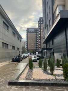 a city street with cars parked in a parking lot at Djal in Bishkek
