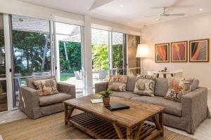 a living room with a couch and a coffee table at Port Douglas Mirage Villa 433 - Beachfront in Port Douglas