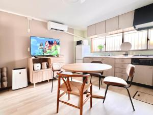 a kitchen with a table and chairs in a room at 海しずくLittle in Kami Amakusa