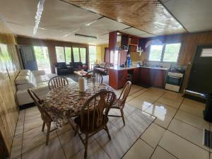 a kitchen and dining room with a table and chairs at Dreaming Dawn in Tofoa