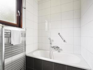 a bathroom with a bath tub with a shower at Holiday Home in South Limburg in Vijlen +13 photos
