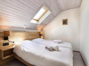 a bedroom with two beds and a skylight at Holiday Home in South Limburg in Vijlen