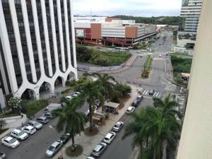 a view of a city with cars parked in a parking lot at Flat 502 América Tower, ao lado do Salvador Shopping in Salvador