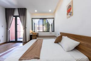 Postel nebo postele na pokoji v ubytování Nắng Homestay Đà Nẵng