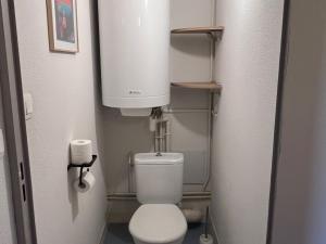 a small bathroom with a toilet and a water tank at Appartement spacieux pour 6 avec terrasse et parking privé - FR-1-814-152 in Super Besse +11 photos