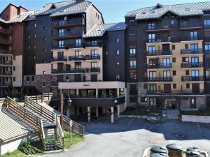 a group of tall buildings in a parking lot at Studio montagne 4 pers, Sud, Ski aux pieds - FR-1-330-592 in Risoul