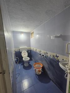 a bathroom with a toilet and a sink at STM StayInn in Nāttarasankottai