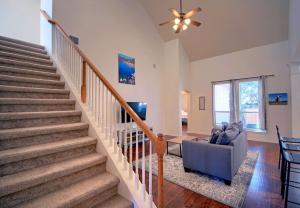 a staircase in a living room with a couch and a fan at Round Rock Family Retreat 4BR 3BA Close to Shopping and Attractions Sleeps 10 in Round Rock