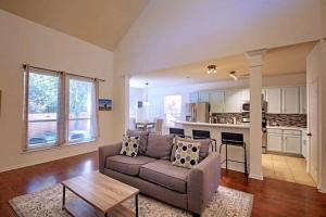 a living room with a couch and a table at Round Rock Family Retreat 4BR 3BA Close to Shopping and Attractions Sleeps 10 in Round Rock