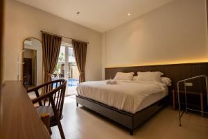 a bedroom with a large bed and a balcony at East Marina Guesthouse in Labuan Bajo +24 photos