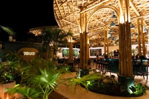 a restaurant with a bunch of tables and chairs at Villa Tokay - The Luxury Resort in Gili Islands