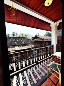a balcony with a view of a train yard at Mueang Nuea Boutique Hotel in Luang Prabang