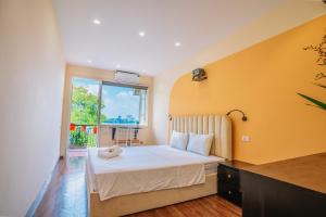 a bedroom with a bed and a window at An Homestay Lakeview Apartment in Hanoi