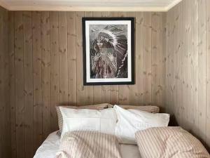 a bedroom with a bed with a picture on the wall at Modern Cabin With Views By Ski Trail In Hadeland in Roa