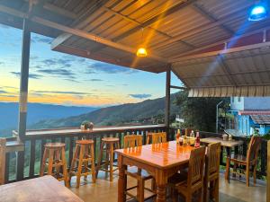 a table and chairs on a balcony with a view at ลักษณ์ภูชี้ฟ้า 2 แบบโดม in Ban Seng Choi +26 photos