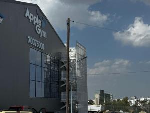 a building with a sign on the side of it at AppleGym sports centre in Laxia