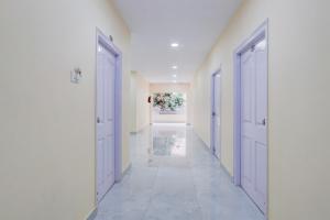 a hallway with two doors at Hotel O Ss ome inn ultra luxury rooms in Ameerpet