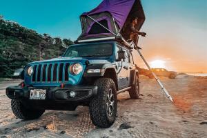 a jeep with a tent on top of it at Island Getaway Camper Cozy Rooftop Tent & Full Gear Kauai in Anahola
