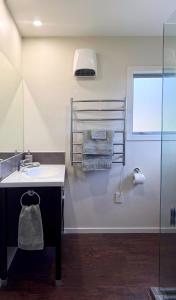 a bathroom with a sink and a shower with towels at Relaxing Rural Retreat - Stargaze or Soak Up the Sun in Luggate