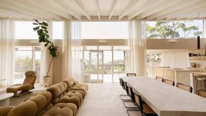 a large dining room with a long table and chairs at Escape to Summer, Bilgola Plateau IH Luxe in Bilgola