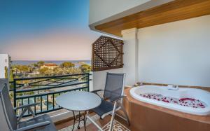 a balcony with a tub and a table and chairs at SH Villa Gadea in Altea
