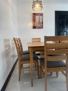 a dining room with a wooden table and chairs at Dollosa Compound in Iba