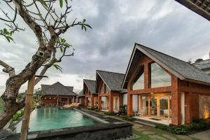 an external view of a house with a swimming pool at Dewi Sri Villa in Ubud