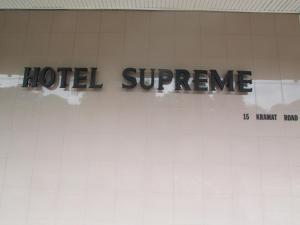 a sign that says hotel supreme on a wall at Hotel Supreme in Singapore