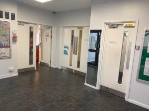 a hallway with doors and a tile floor at Deanery Student Residence in Southampton
