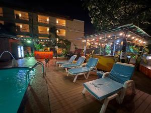 a swimming pool with lounge chairs and a hotel at LAY TONG BEACH HOTEL Patong in Patong Beach