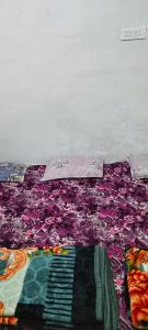 a close up of a colorful blanket on a bed at Shiv kripa guest house in Sehore