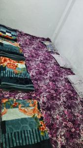 a group of quilts on the floor in a room at Shiv kripa guest house in Sehore