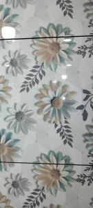 a pattern of flowers on a tile floor at Shiv kripa guest house in Sehore