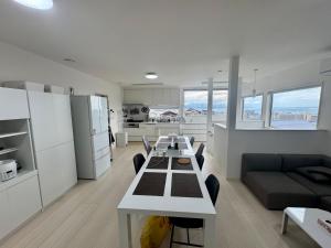 a kitchen and living room with a table and a couch at 嘉翔の家 in Otsu