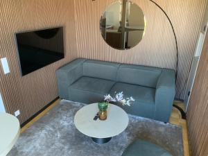 a living room with a blue couch and a table at Core Luxembourg City - Schuman in Luxembourg
