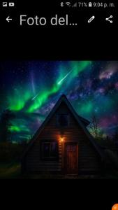 an image of a house with the northern lights at Refugio Holístico Flora Boreal in El Bolsón